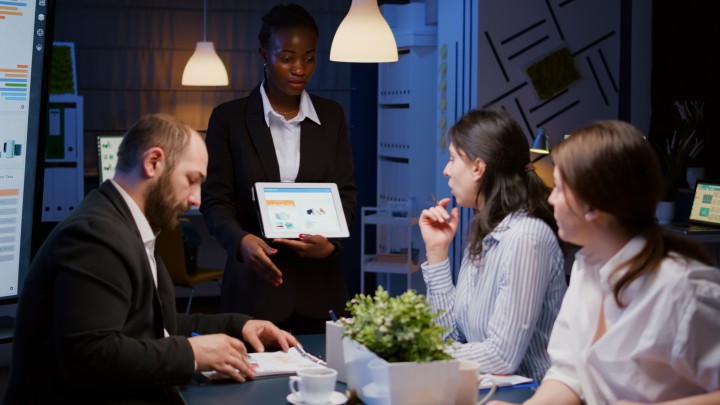 focused-workaholic-african-american-businesswoman-showing-financial-graphs-tablet (1)